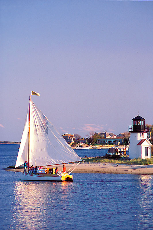 Sailboat-and-Lighthouse-Cape-Cod,-MA,-USA