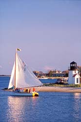 Sailboat-and-Lighthouse-Cape-Cod,-MA,-USA